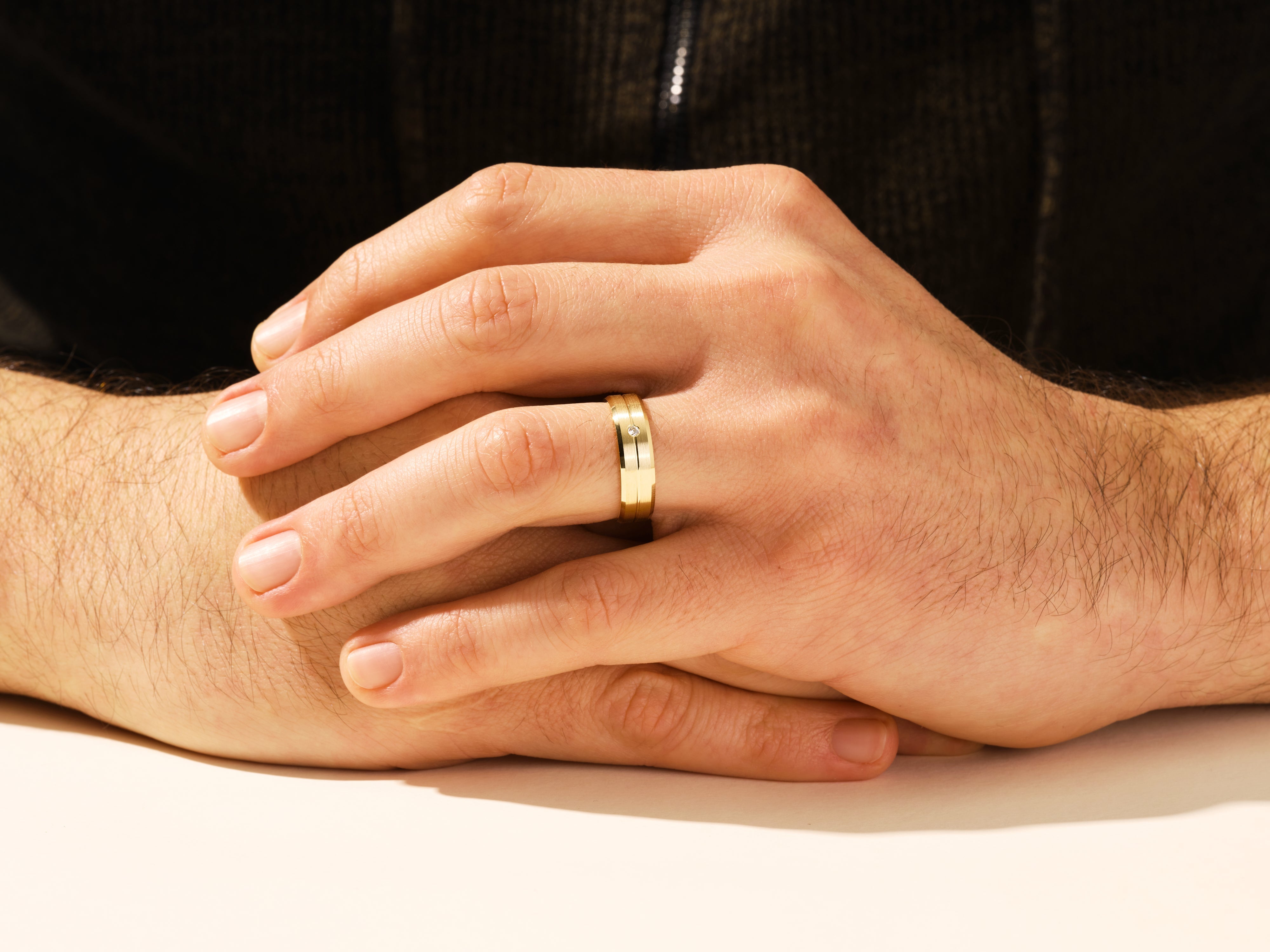 Gold ring with diamond on man's hand, jewelry