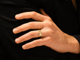 Gold ring with diamonds on a man's hand
