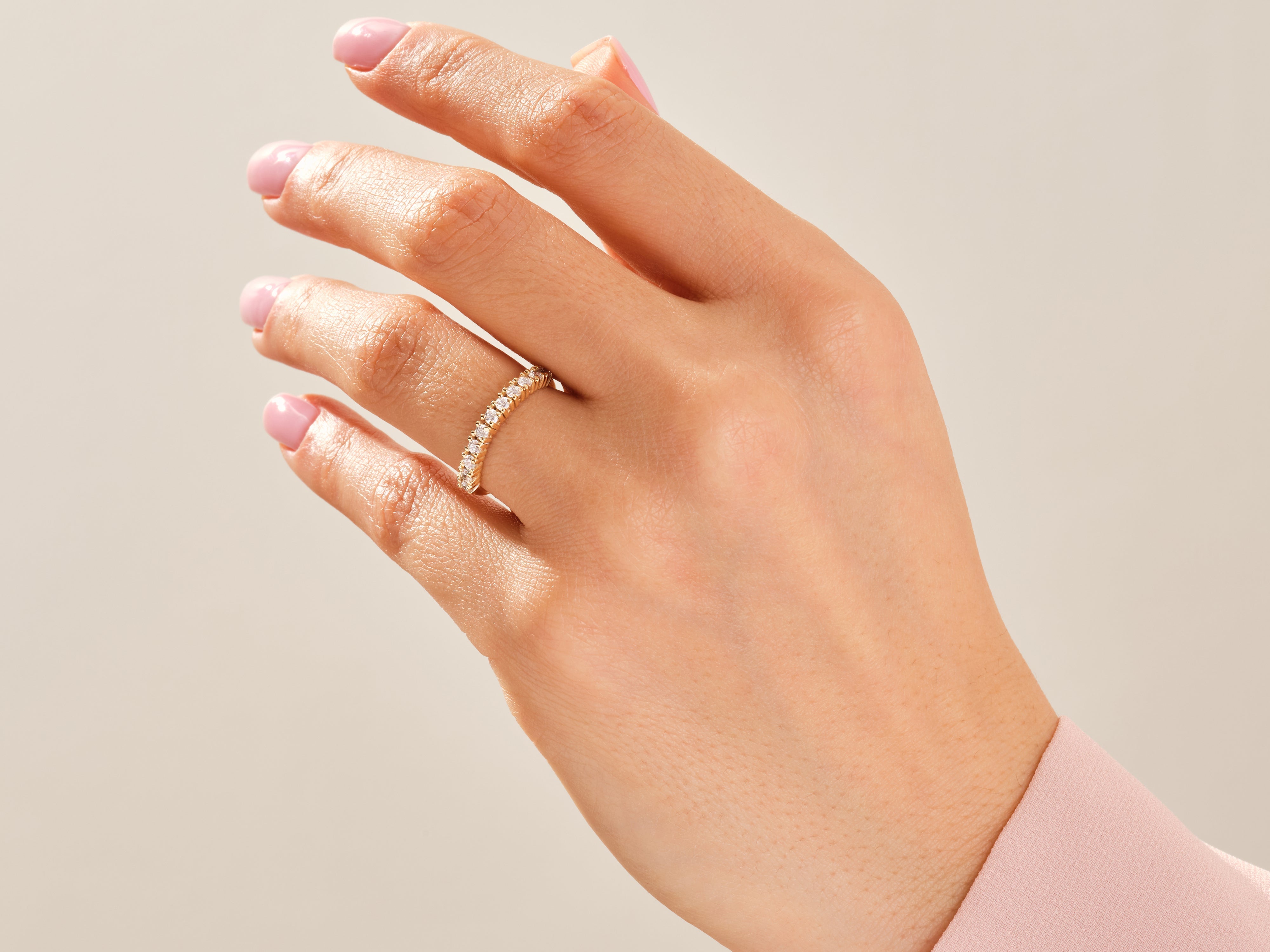 Diamond eternity band on a woman's hand, fine jewelry