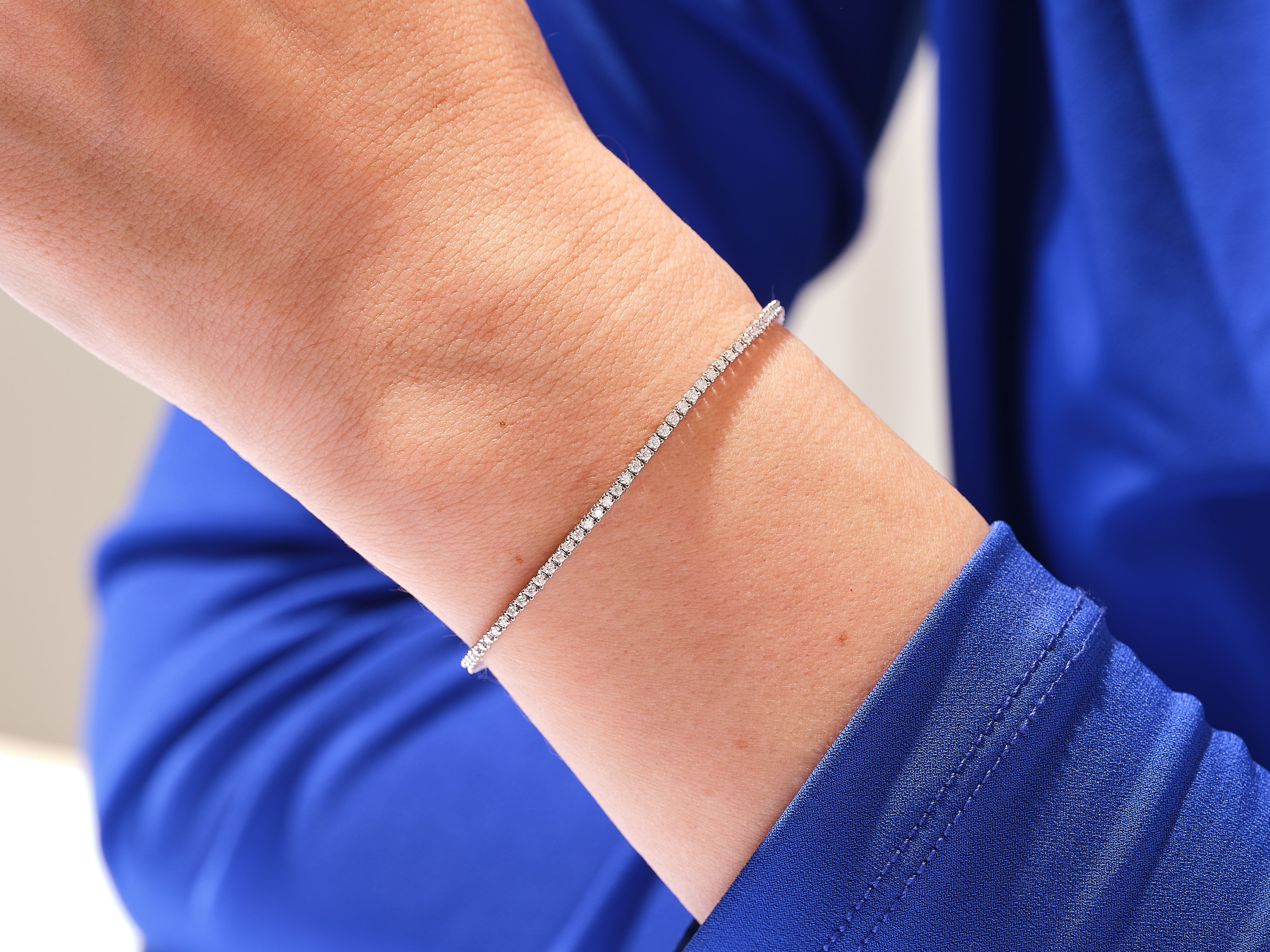 Diamond tennis bracelet on a woman's wrist, fine jewelry