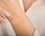 Gold snowflake bracelet with diamond accent on wrist