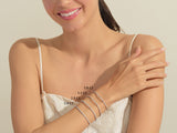 Diamond tennis bracelets in various carat weights on a woman's wrist