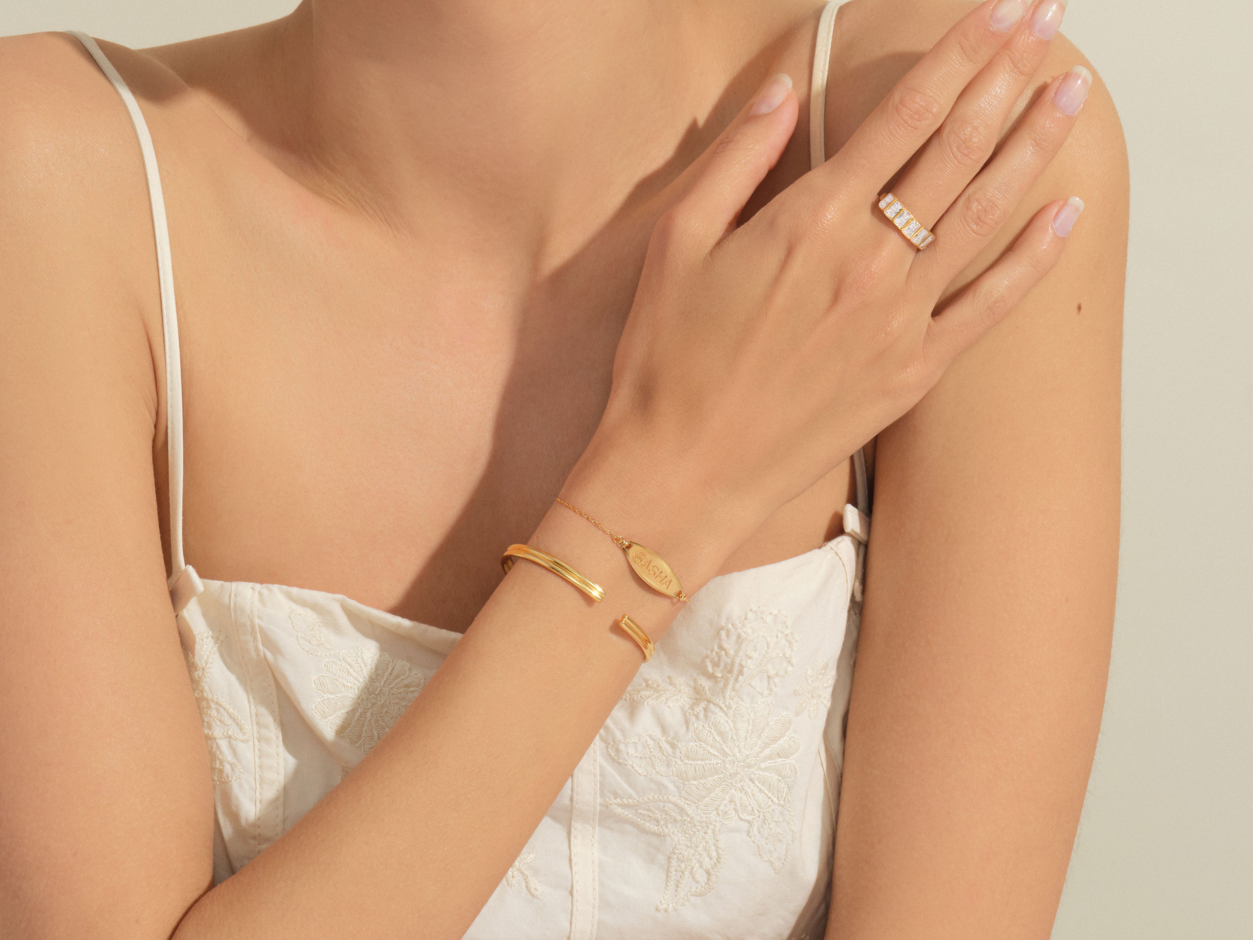 Gold bracelet and ring on a woman's arm
