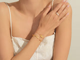 Gold bracelet and ring on a woman's arm