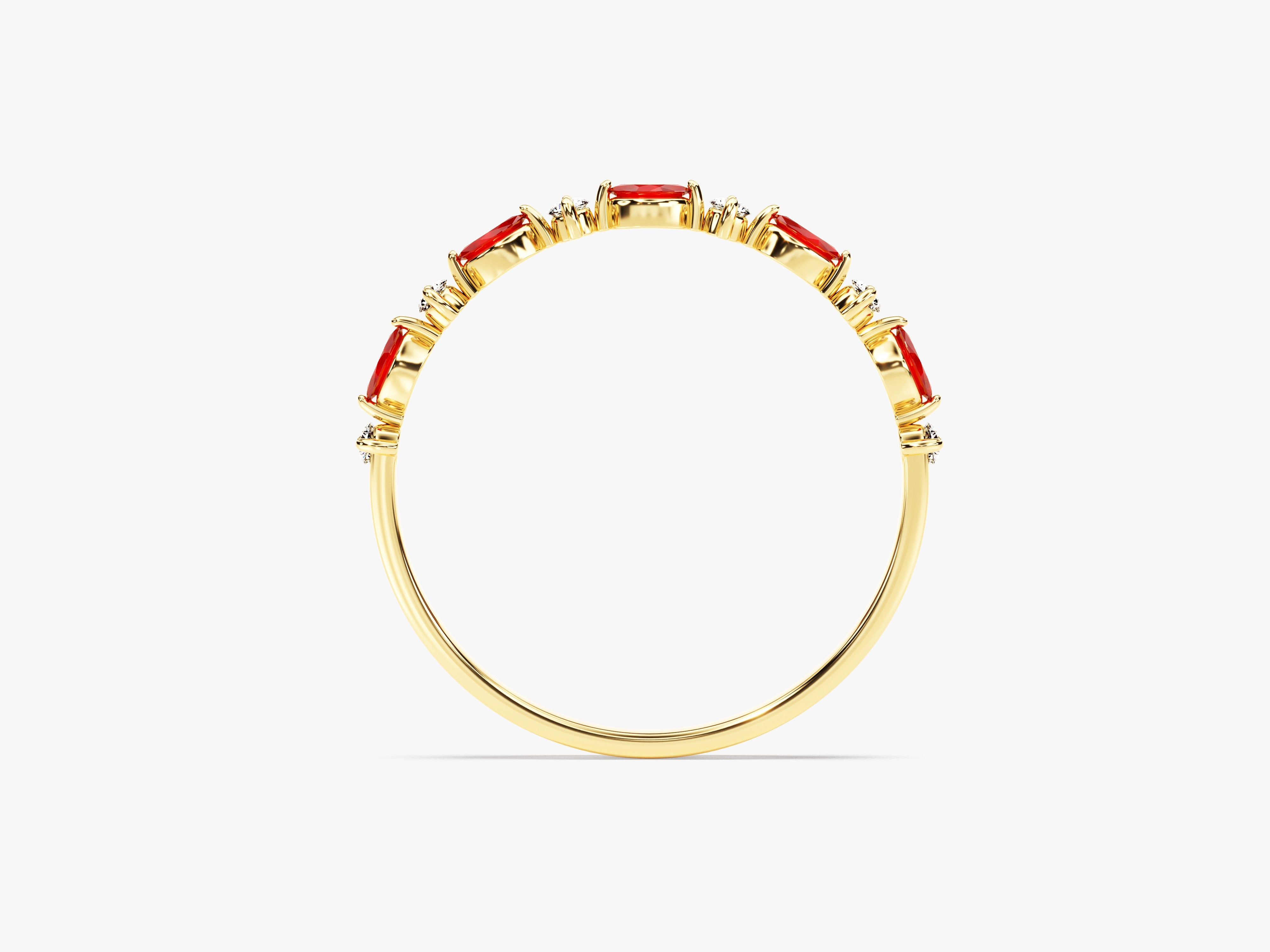Gold ring with oval red gemstones and diamonds