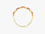 Gold ring with oval red gemstones and diamonds
