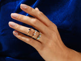 Gold rings with colorful gemstones on a hand