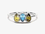 Three pear-shaped gemstones on a silver ring, fine jewelry
