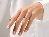 Gold ring with "mom" inscription on a woman's finger