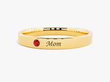 Gold ring with red gemstone and "Mom" engraving