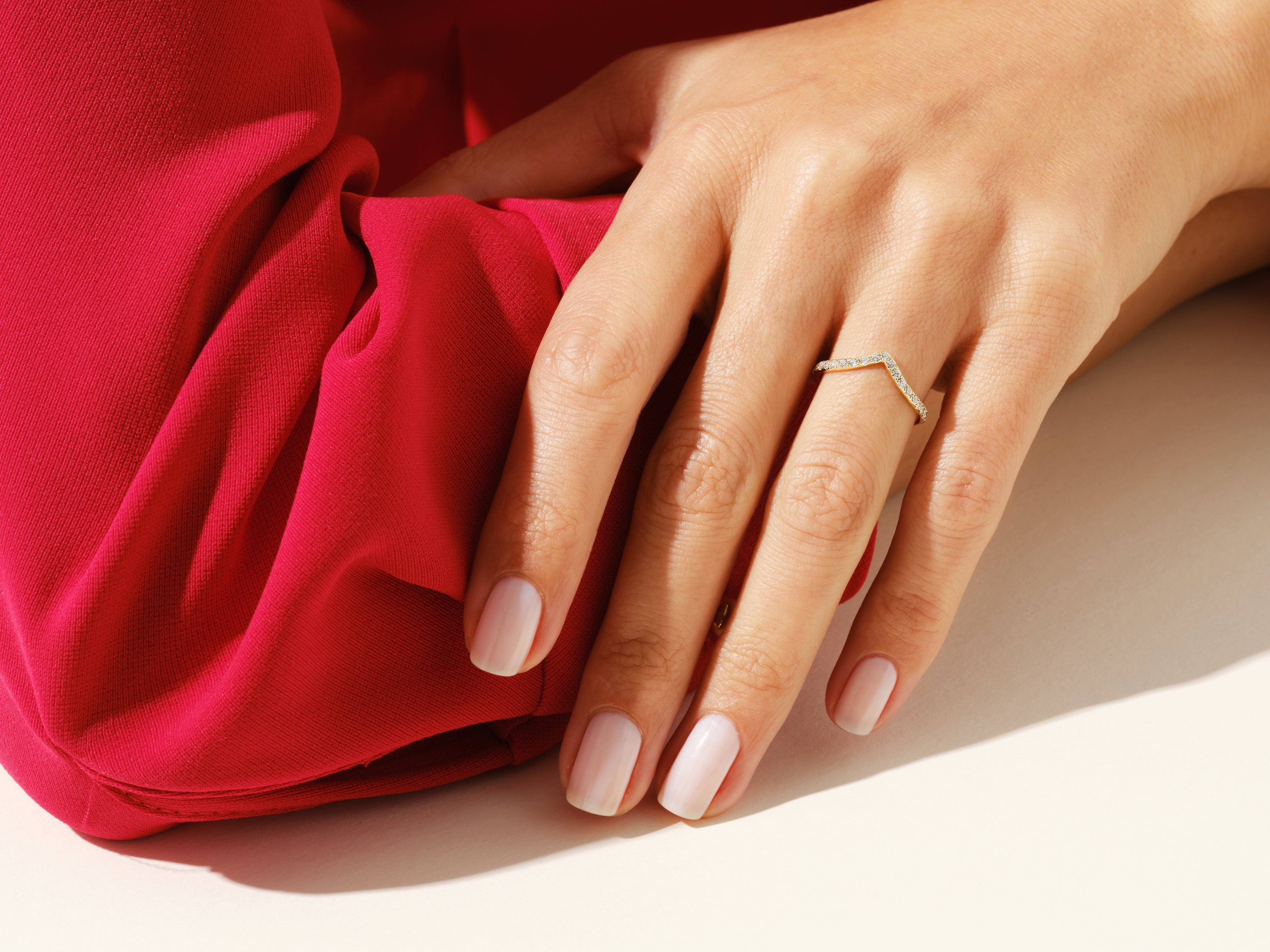 Diamond chevron ring on hand, luxury jewelry