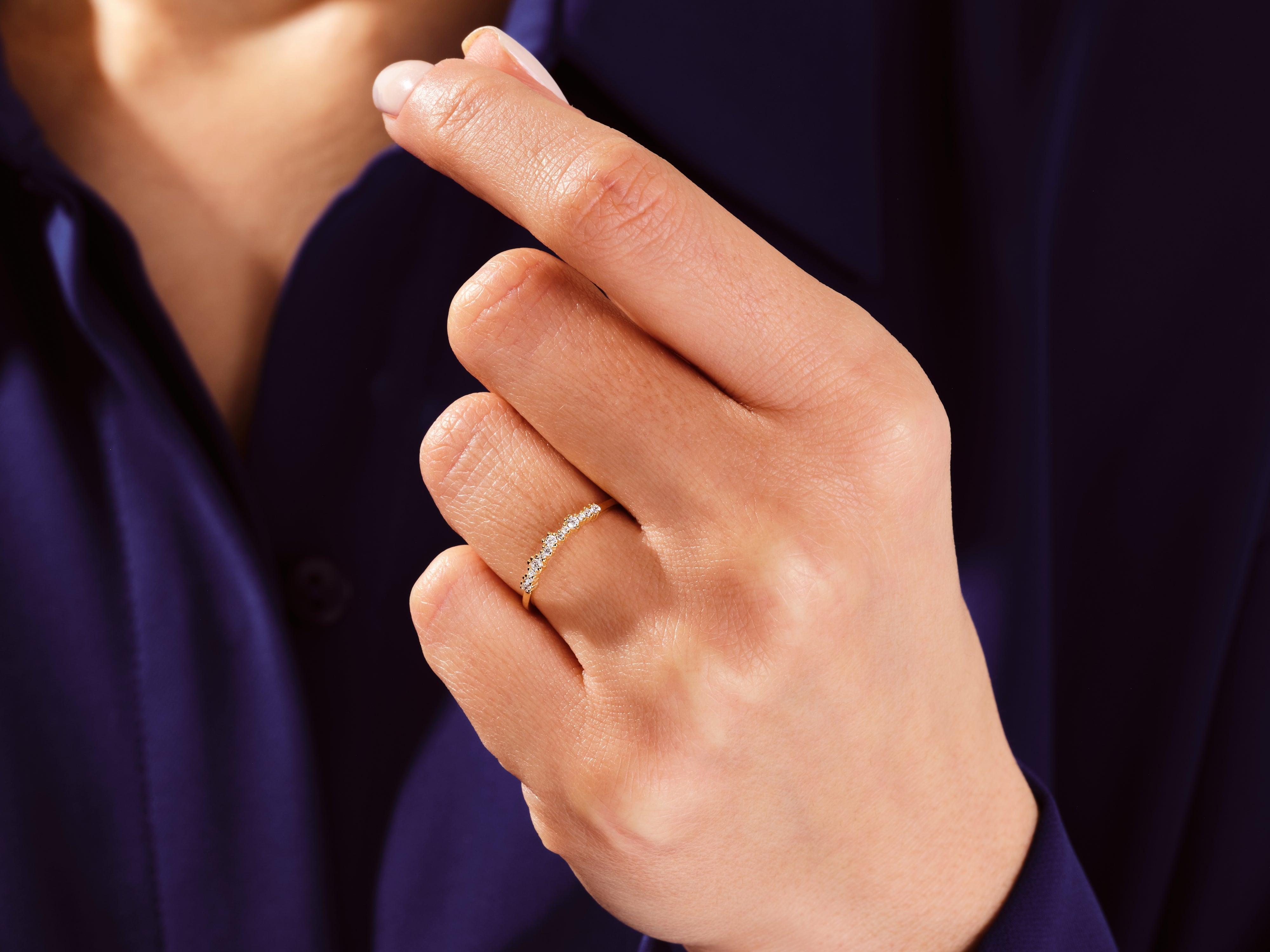 Gold diamond ring on a woman's finger, jewelry product