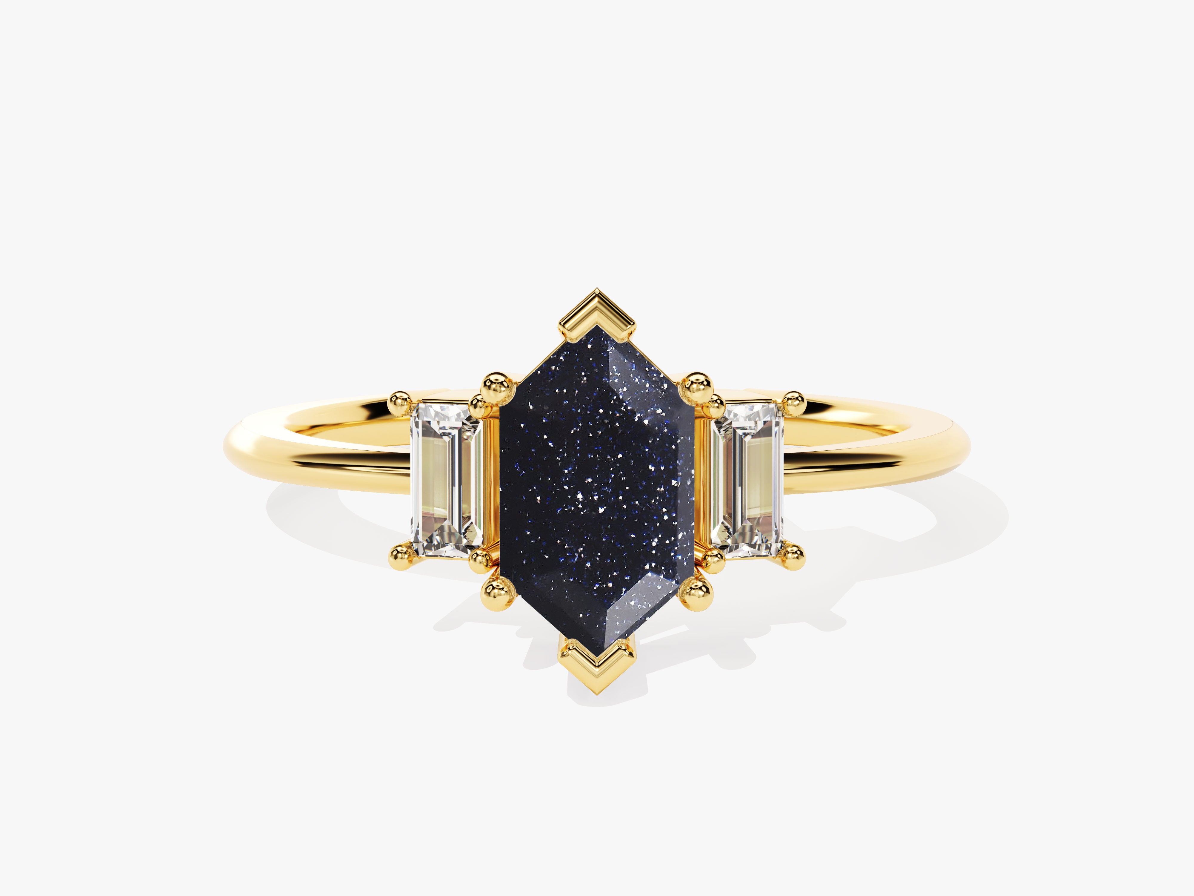 Gold ring with dark blue speckled gemstone and baguette diamonds