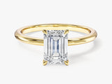 Emerald cut diamond ring in yellow gold setting