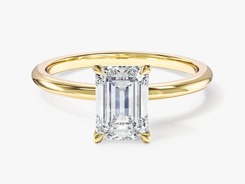 Emerald cut diamond ring in yellow gold setting