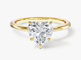 Gold ring with heart-shaped diamond engagement ring