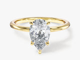 Gold ring with pear-shaped diamond engagement ring