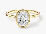 Oval diamond engagement ring in yellow gold setting