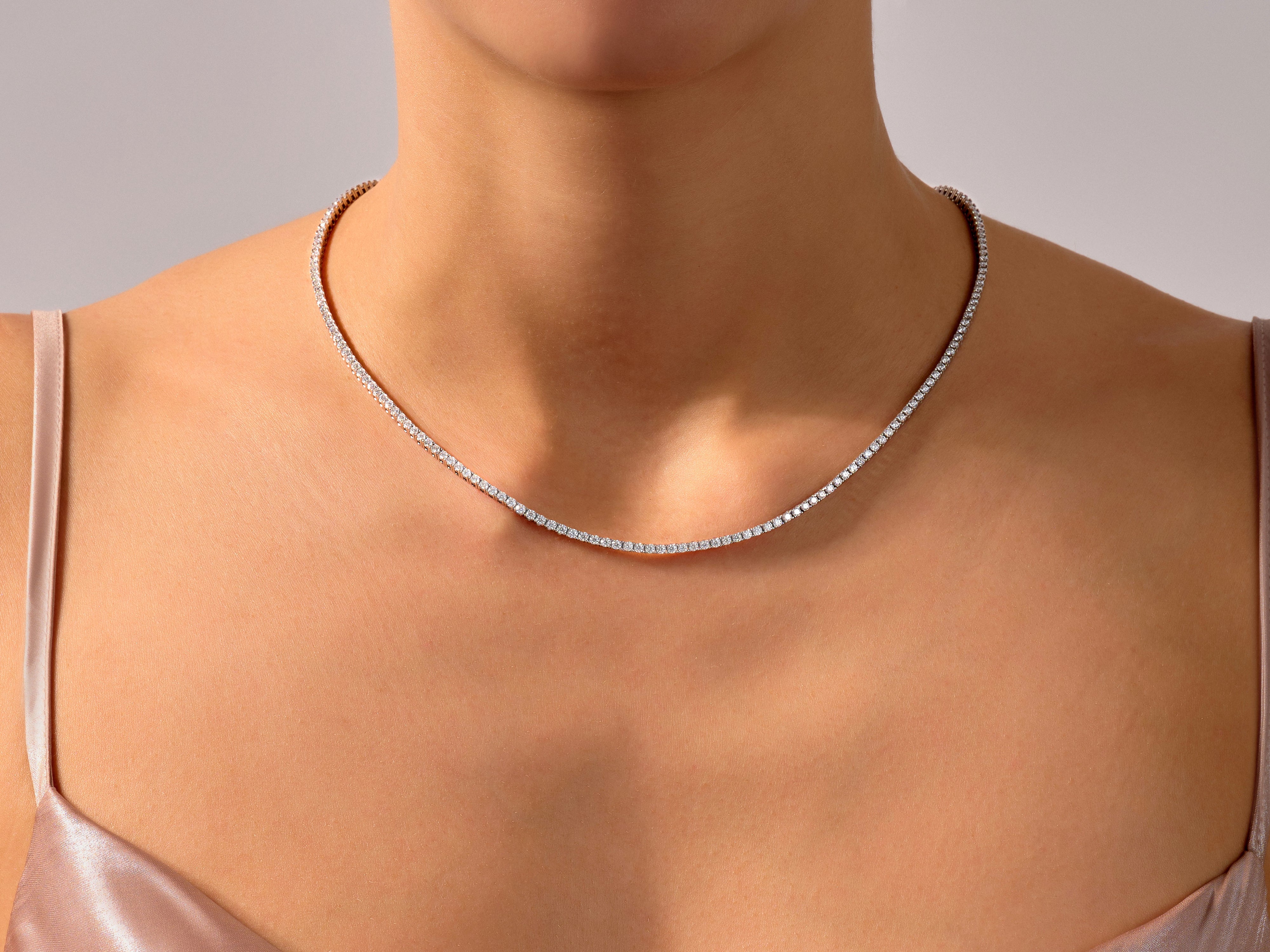 Diamond tennis necklace on a woman's neck, fine jewelry