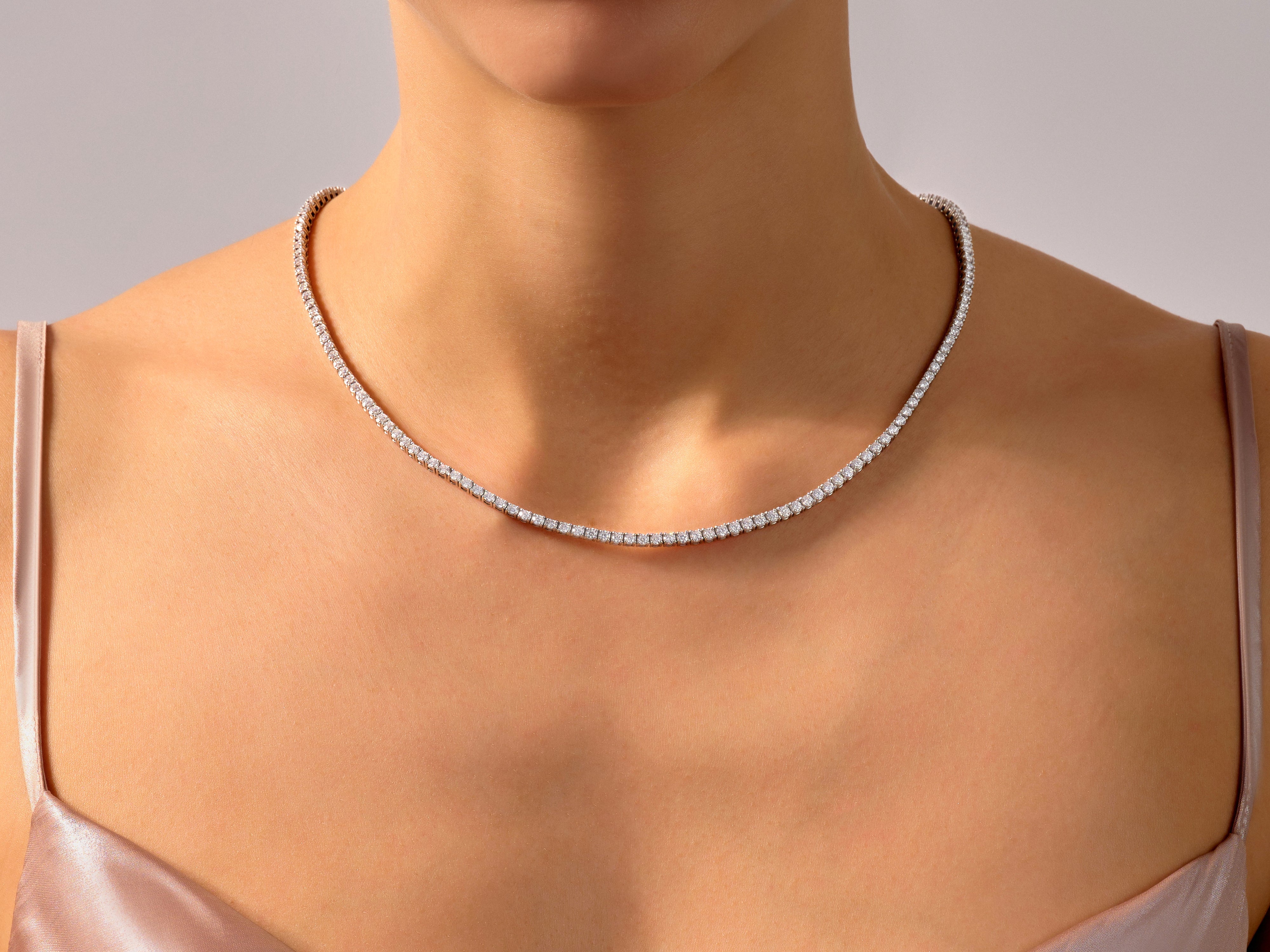 Diamond tennis necklace on a woman's neck, fine jewelry