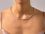 Diamond tennis necklace on a woman's neck, fine jewelry