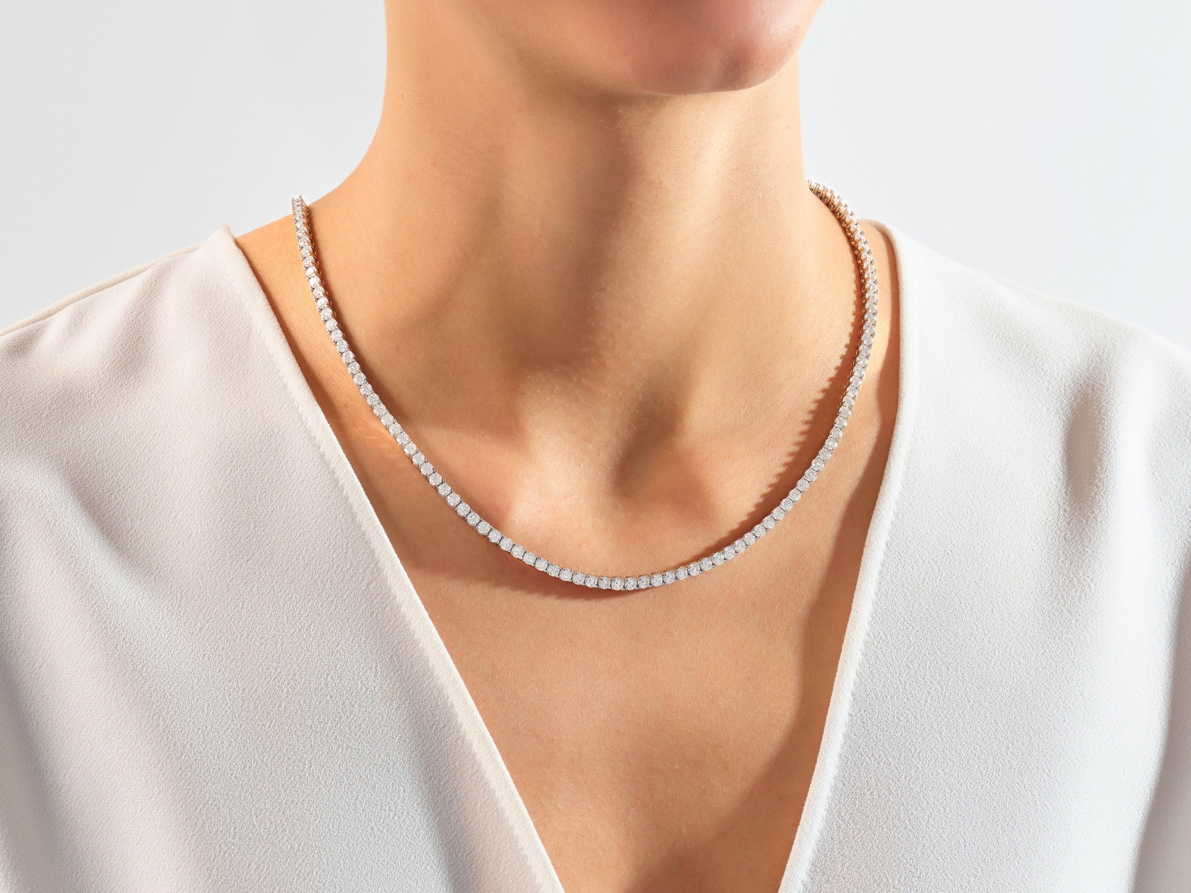 Diamond tennis necklace on a woman's neck, fine jewelry
