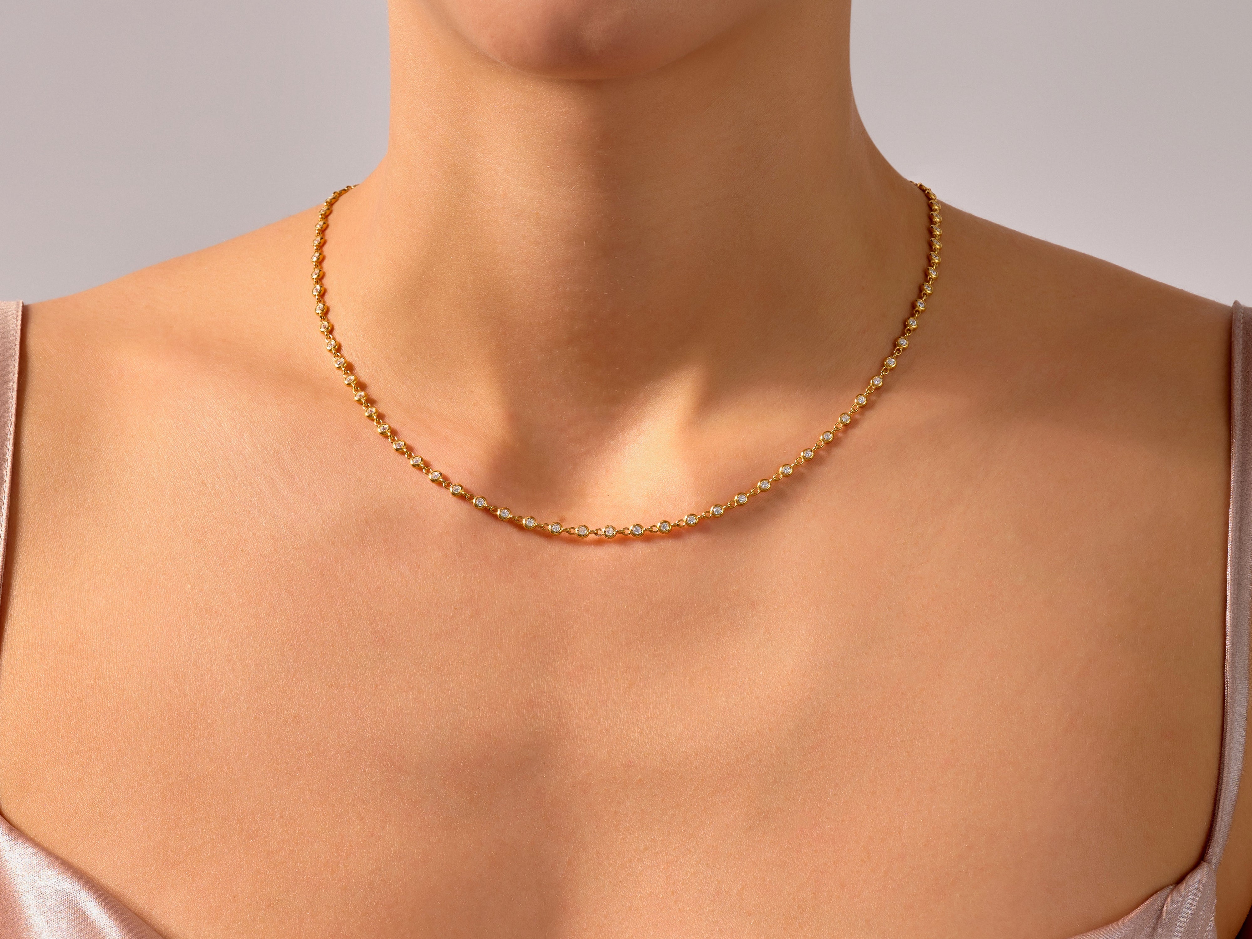 Gold diamond necklace on a woman's neck