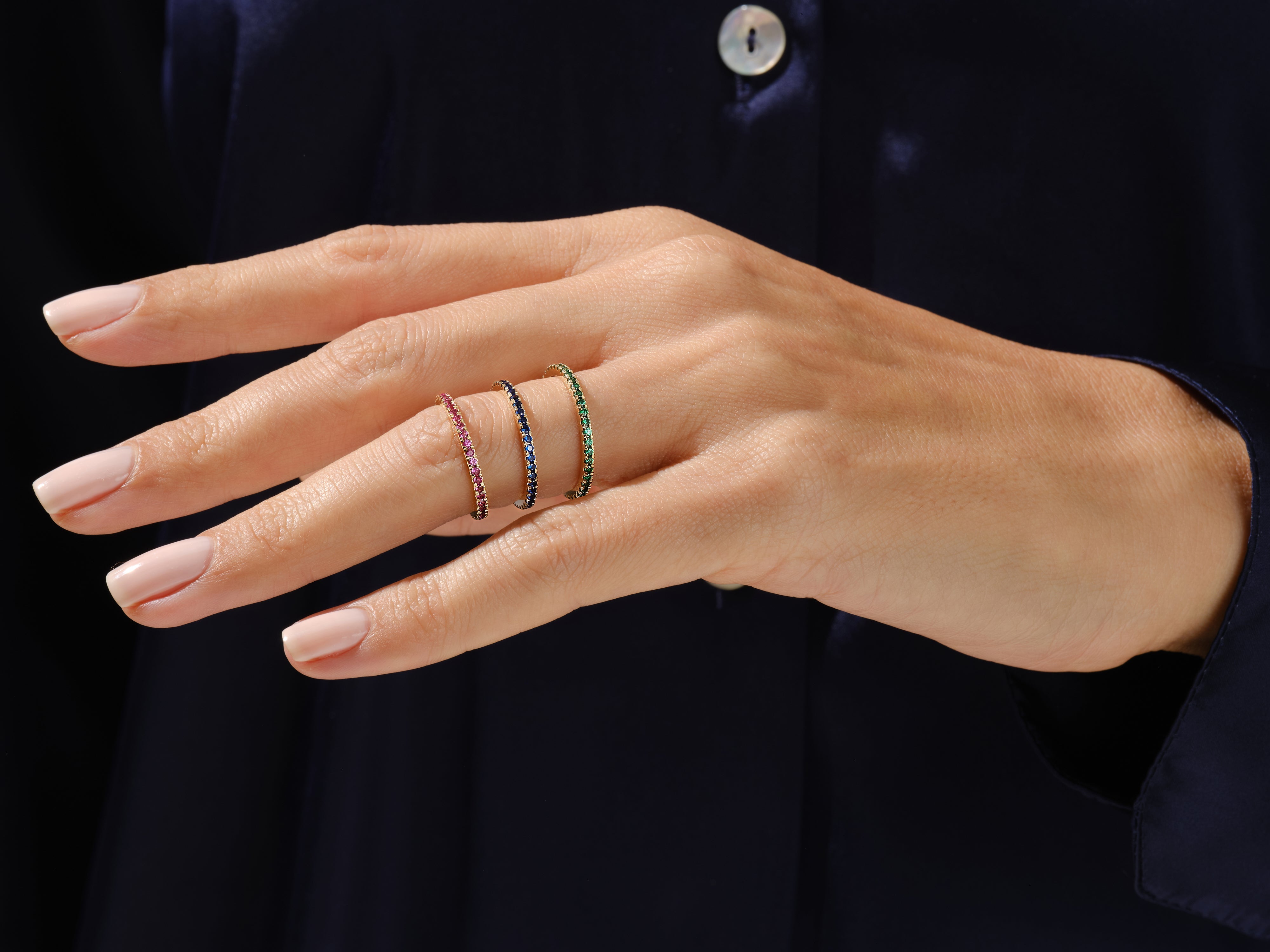 Stackable gemstone rings on a hand, fine jewelry for women
