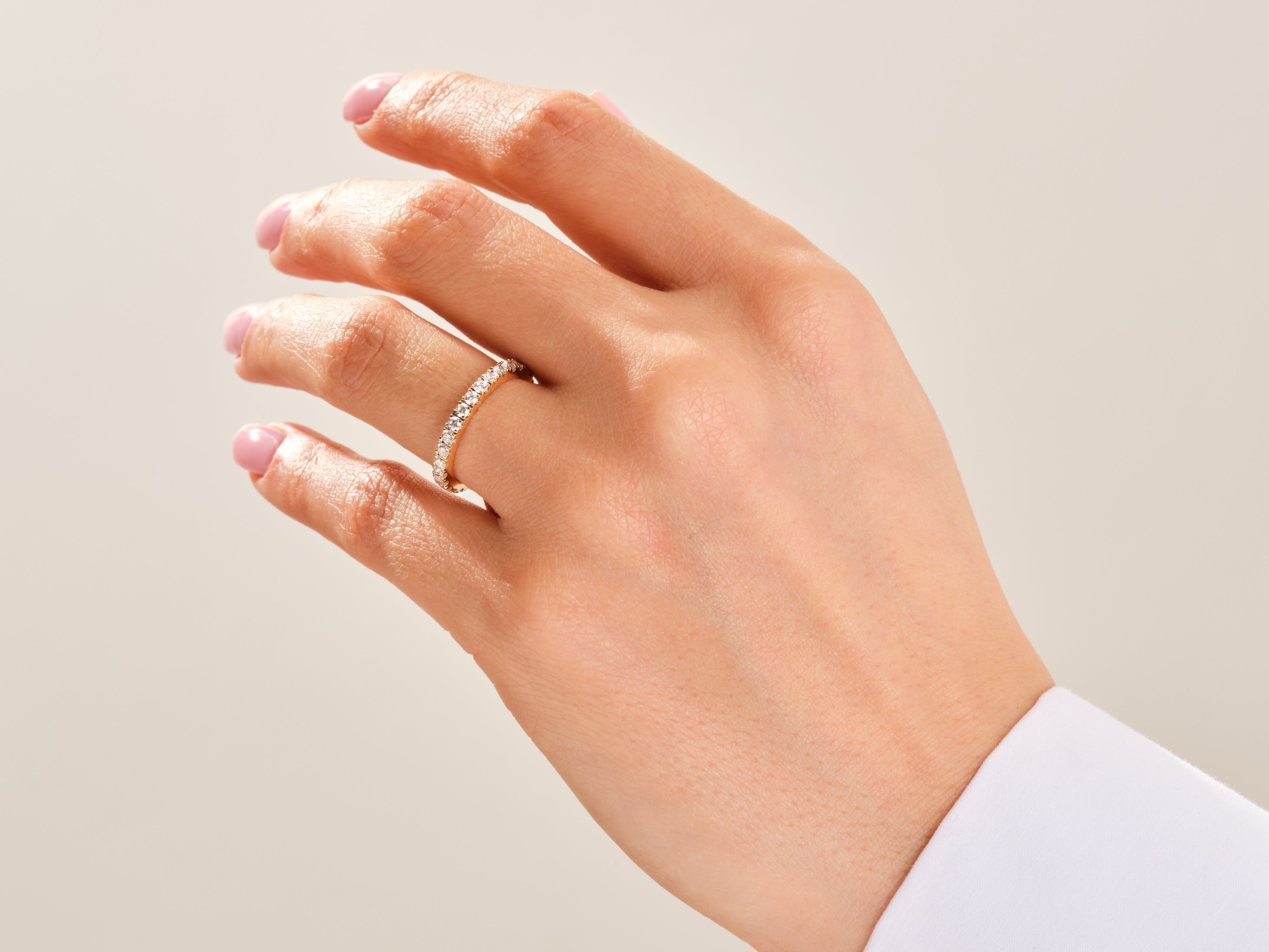 Diamond eternity ring on a woman's hand, jewelry photography
