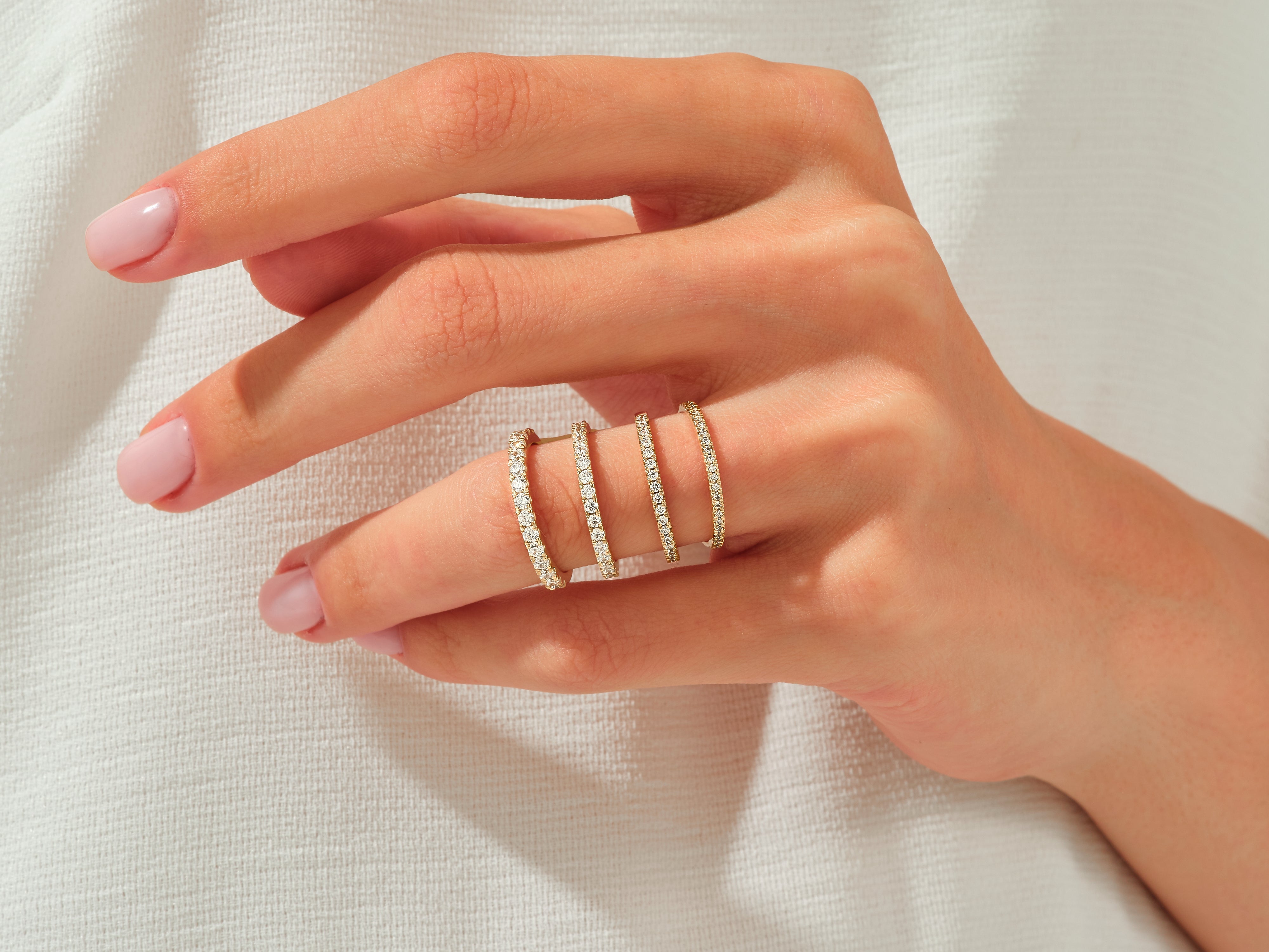 Diamond eternity rings on a hand, jewelry collection