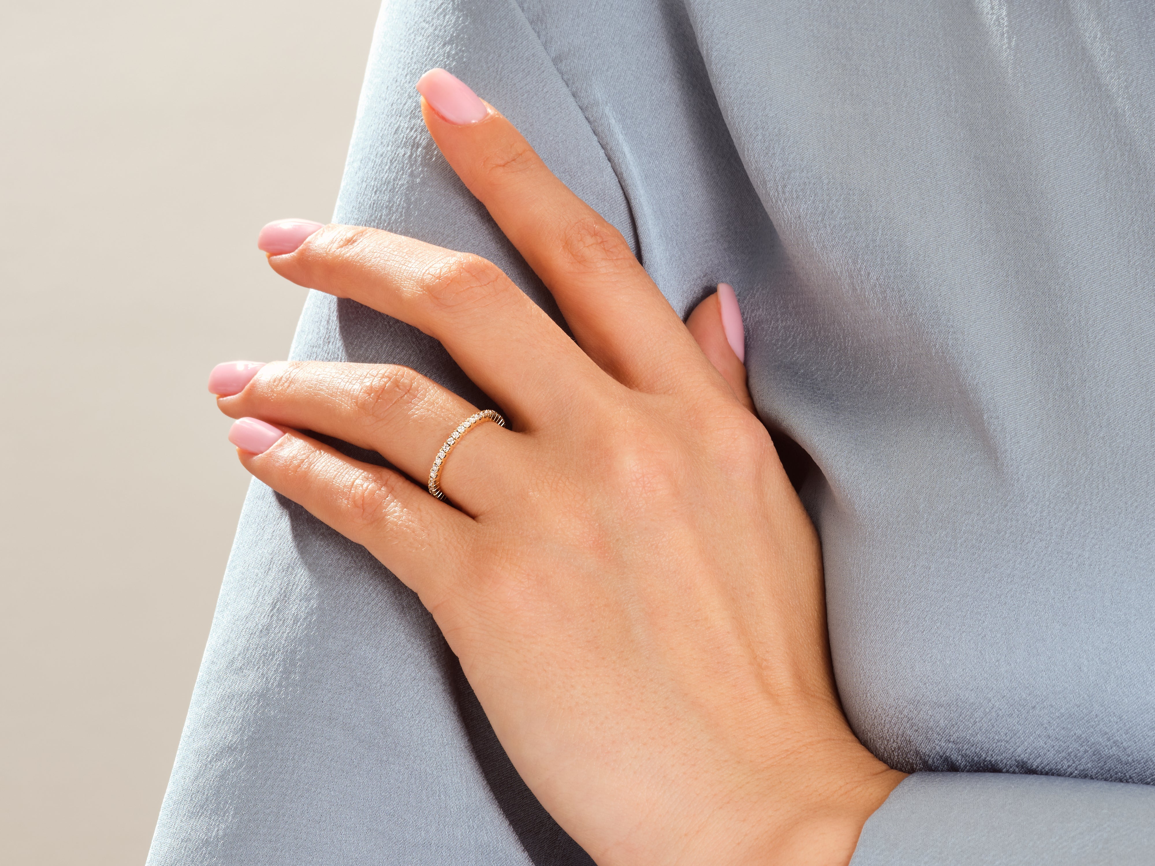 Diamond eternity ring on a hand, jewelry product photography