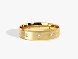 Gold wedding band with scattered diamonds, brushed finish, jewelry
