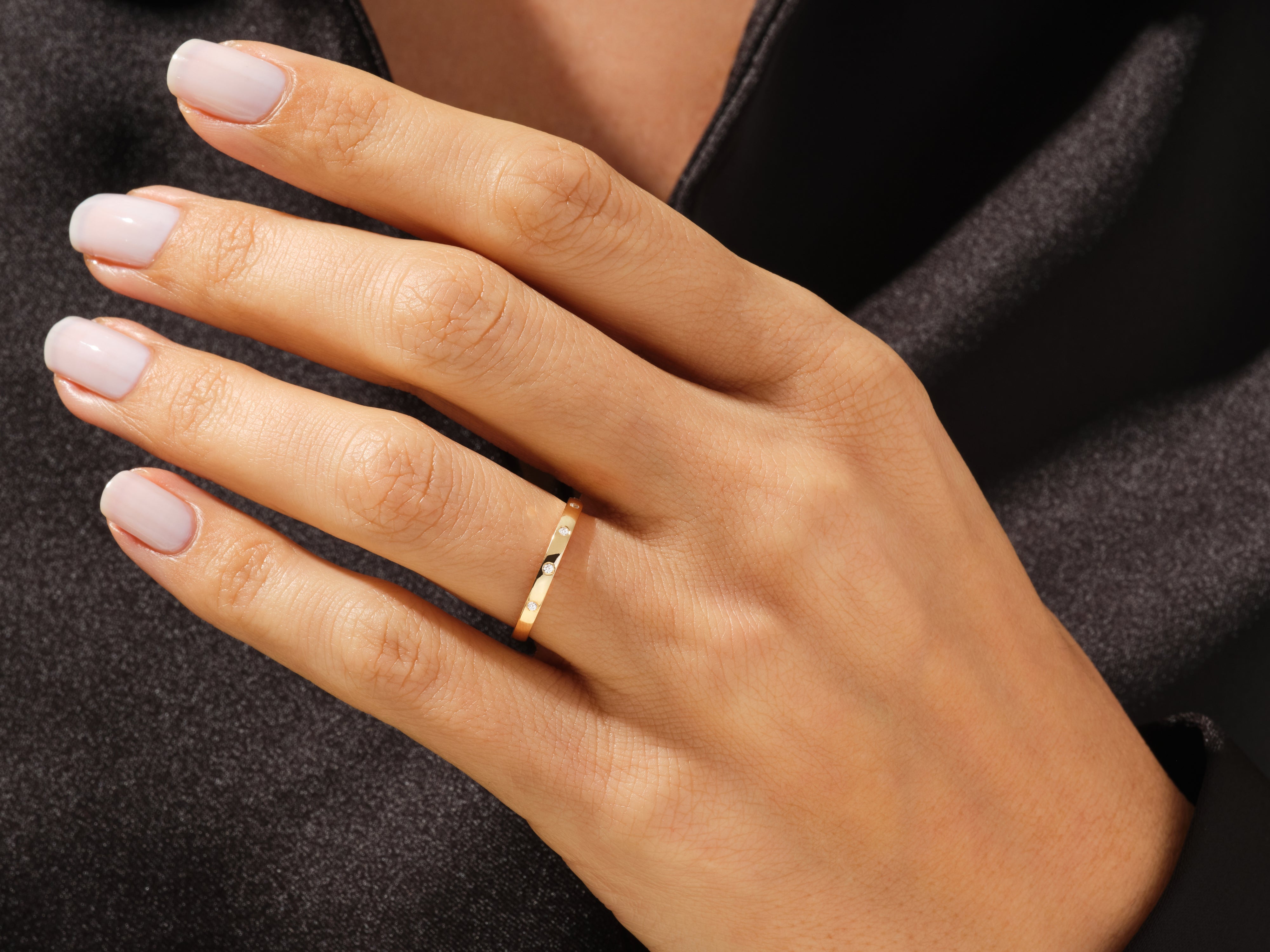 Gold diamond band ring on a woman's finger