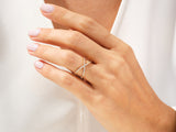 Diamond criss-cross ring on a woman's hand, fine jewelry