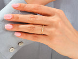 Gold diamond band ring on a woman's finger