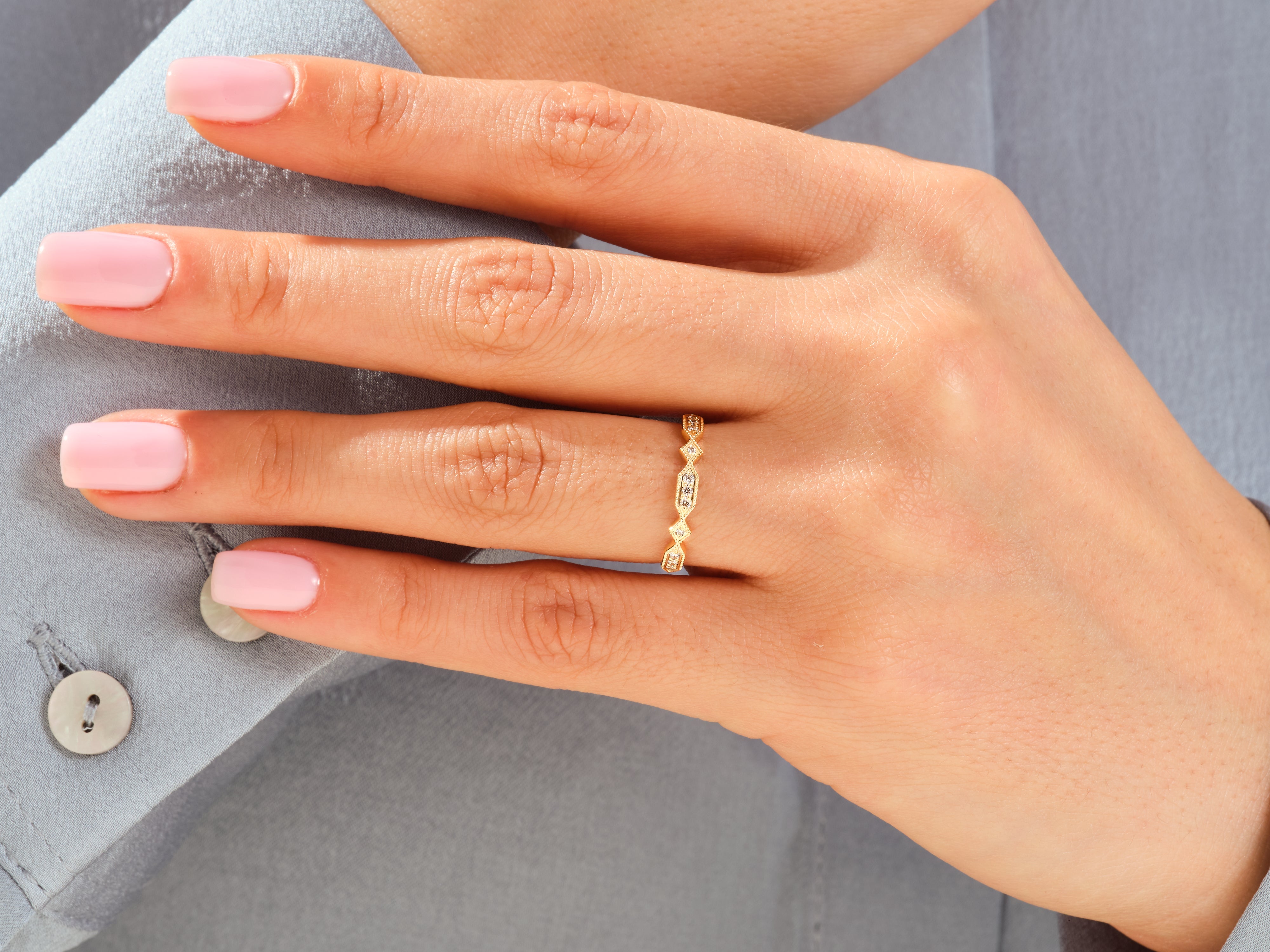 Gold diamond ring on a woman's finger