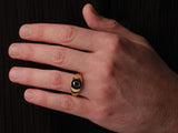 Gold ring with black stone on man's finger jewelry