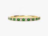 Gold band ring with alternating emeralds and diamonds