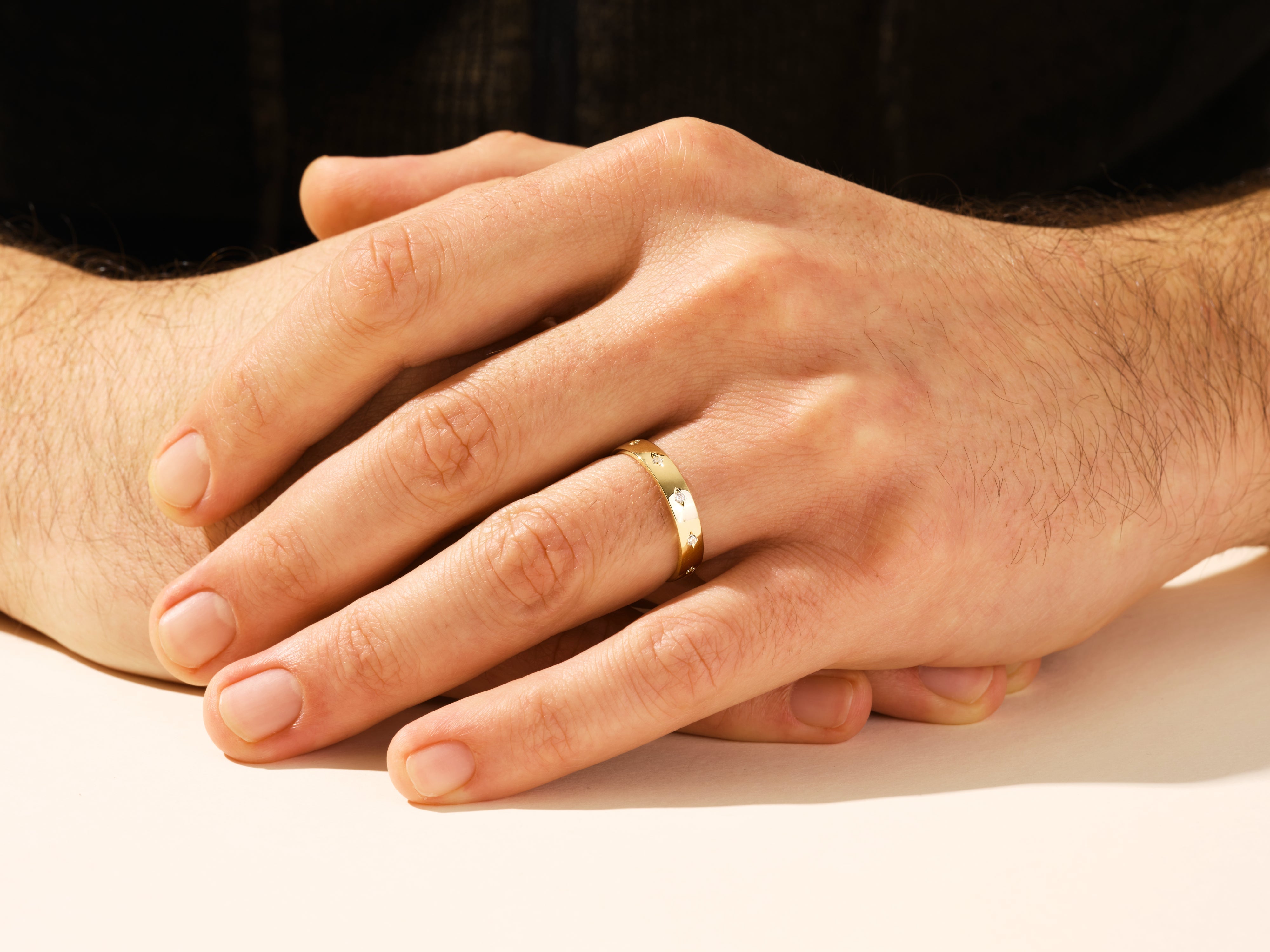 Gold ring with diamonds on a man's hand