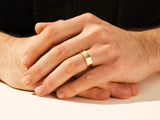 Men's gold wedding band on hand, jewelry photography