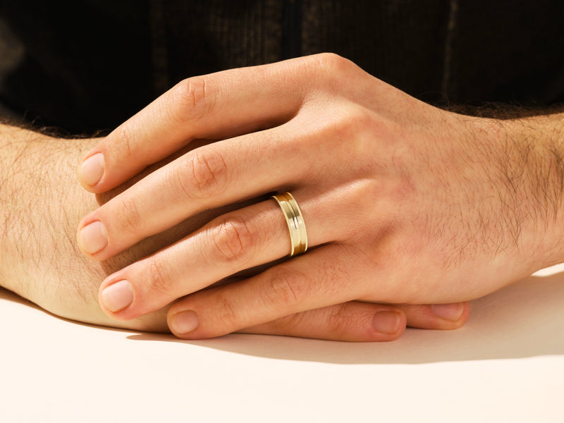 Men's gold wedding band on hand, jewelry firm product