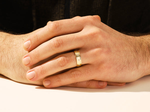 Gold ring with diamonds on a man's finger, jewelry