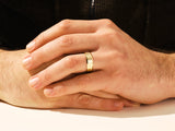 Gold wedding band on man's hand, jewelry product photography