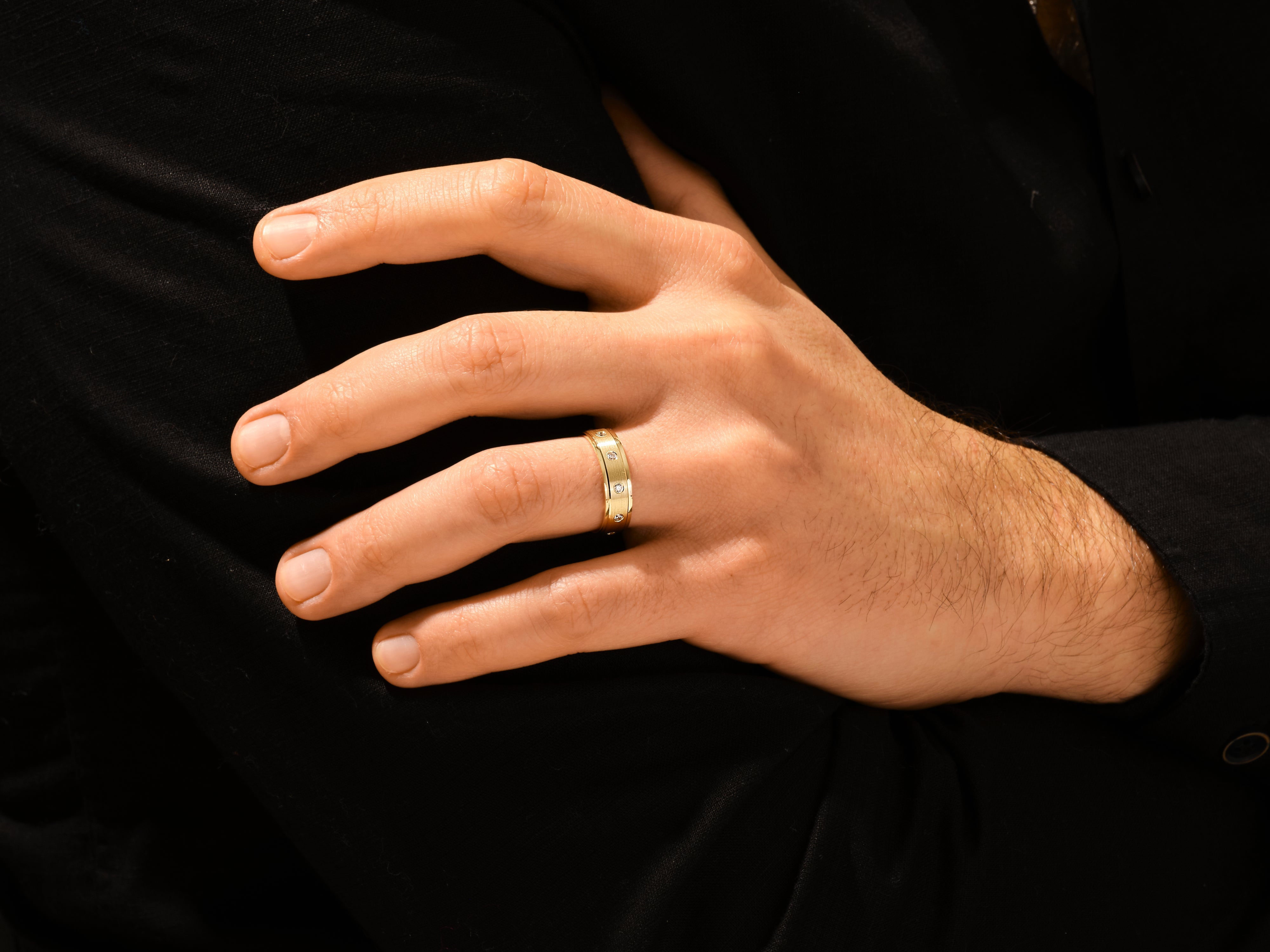Gold ring with diamonds on a man's hand