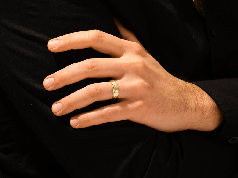 Gold ring with diamonds on a man's hand