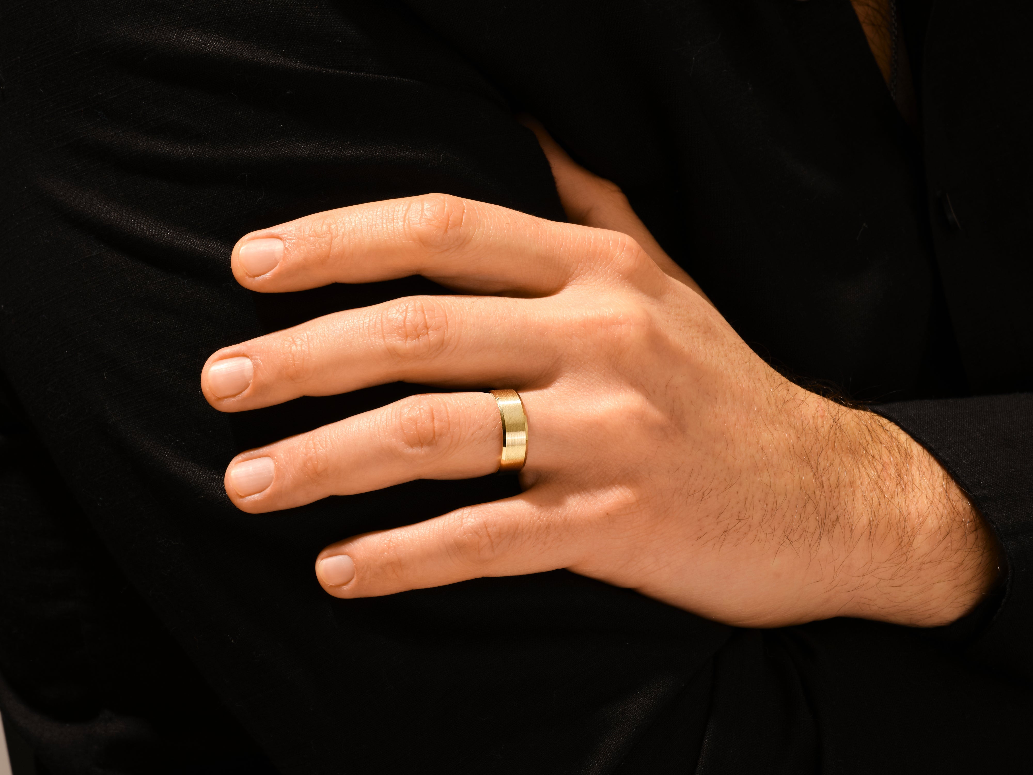 Gold wedding band on man's hand, jewelry for him