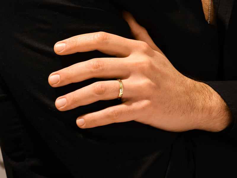 Gold ring with diamonds on a man's hand