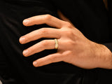 Gold hammered ring on a man's finger, jewelry photography