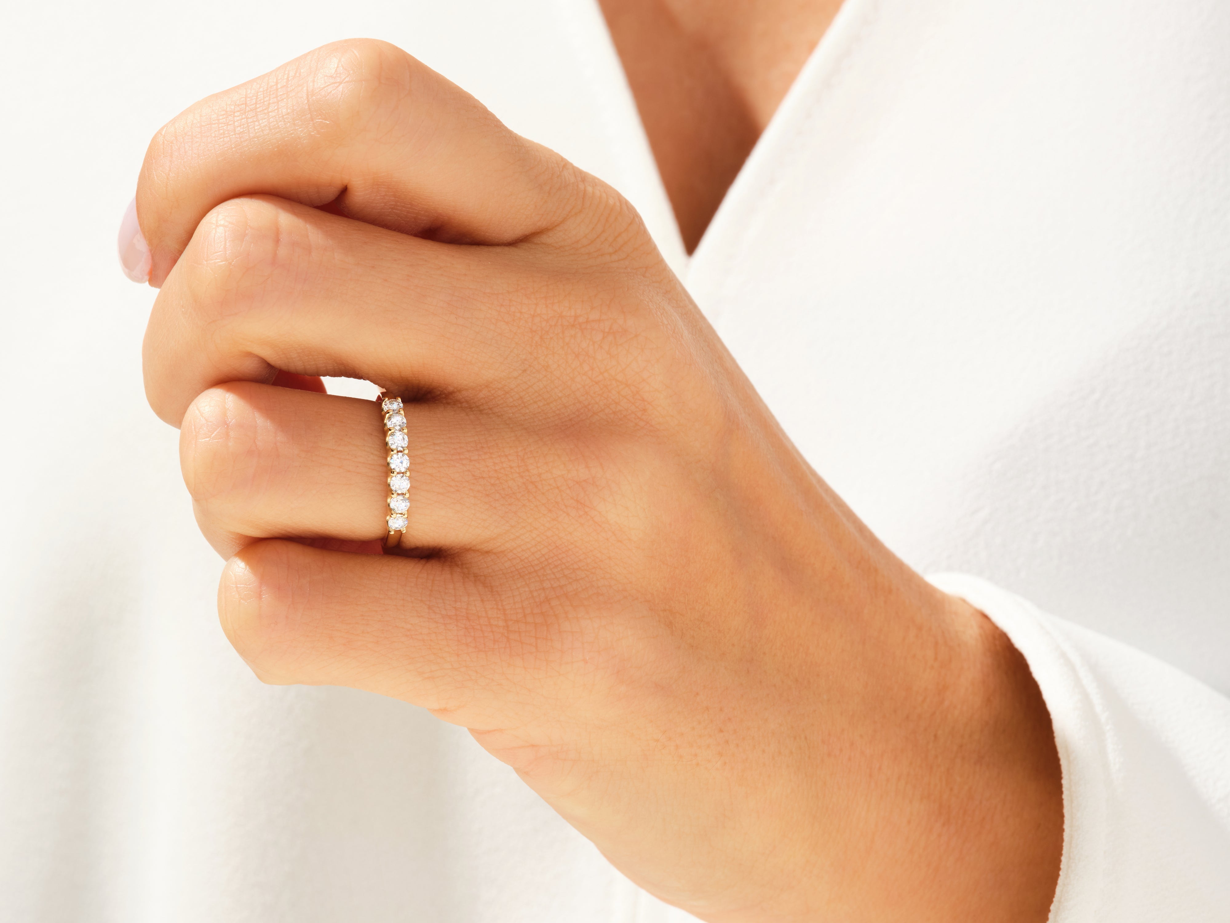 Diamond eternity ring on a woman's finger, jewelry product