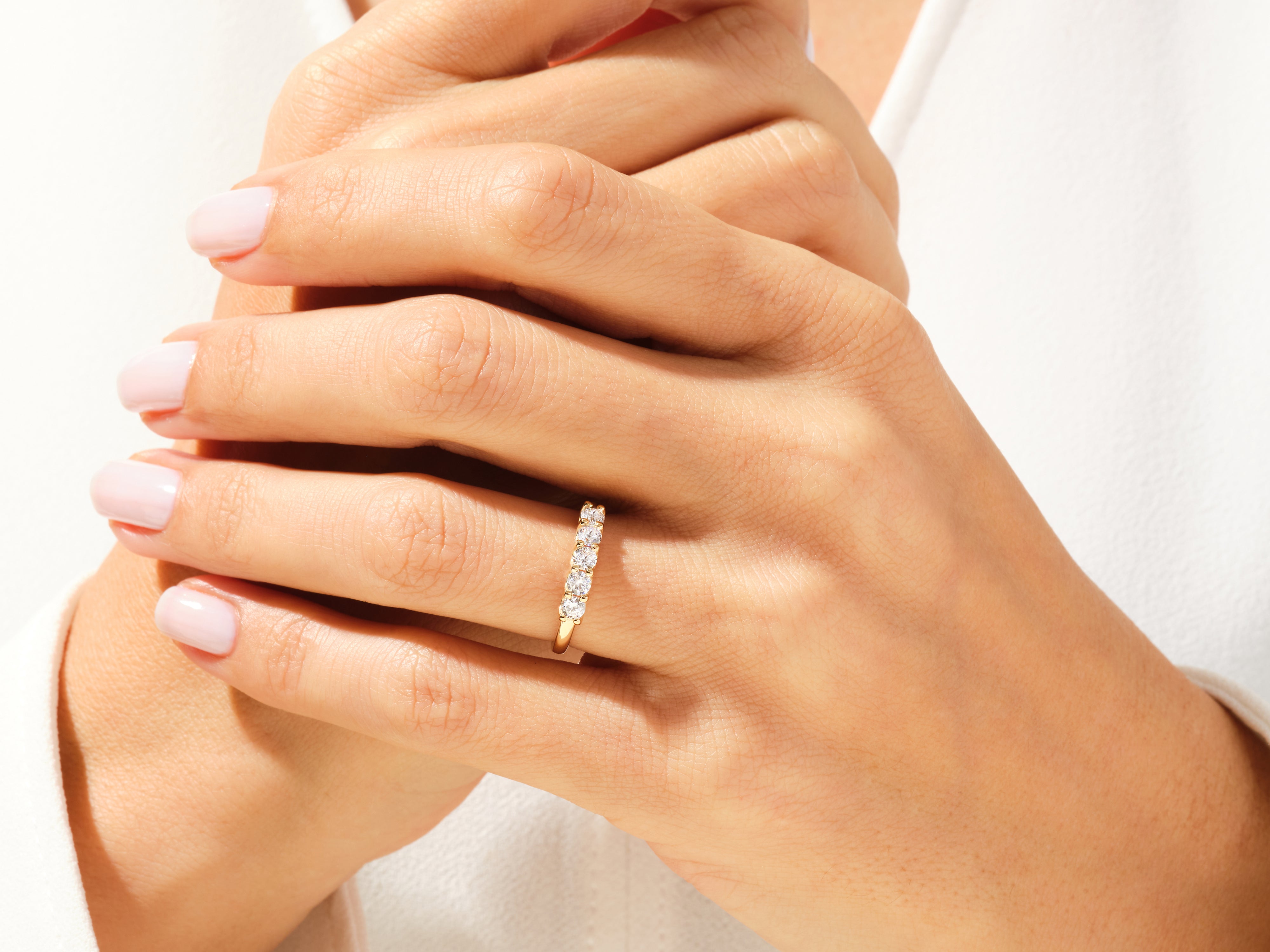 Diamond band ring on a woman's hand, fine jewelry